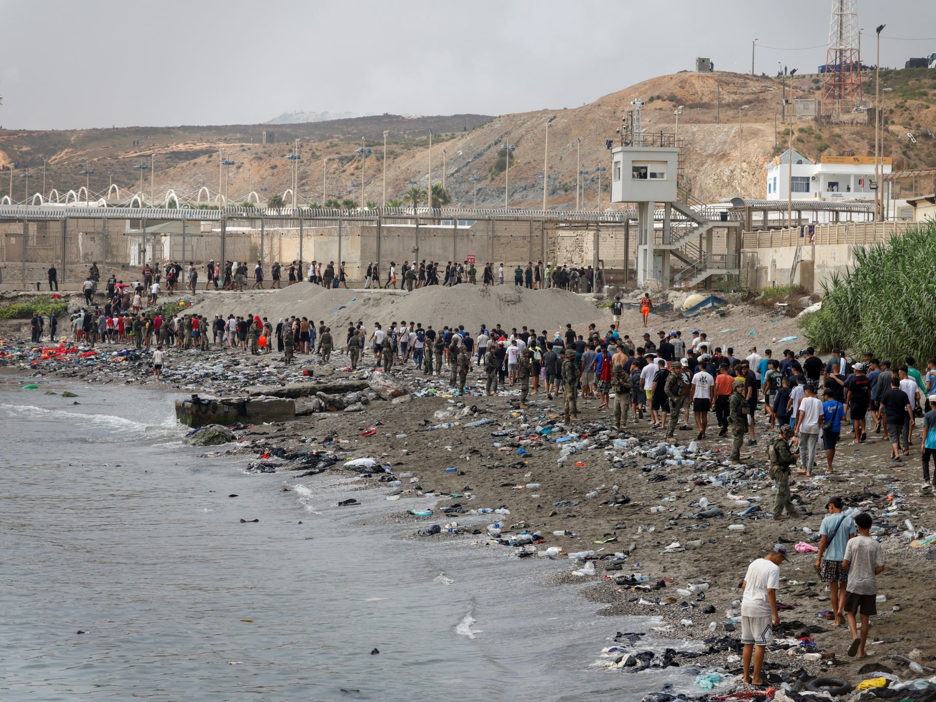 People walk towards the border with Morocco leaving Spain, amid mass crossings of migrants on foot and by sea from Morocco into Spanish territory, in Ceuta, Spain, July 31, 2026. REUTERS/Jon Nazca TPX IMAGES OF THE DAY