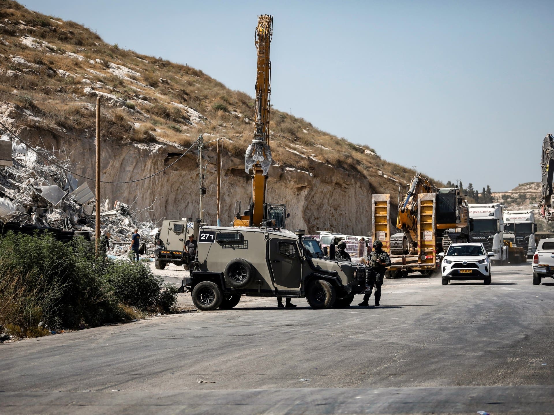 Israeli forces oversee the demolition of a building containing shops and flats, citing the lack of a building permit, in Anzah, south of the Palestinian city of Jenin, in the northern Israeli-occupied West Bank on July 27, 2026.