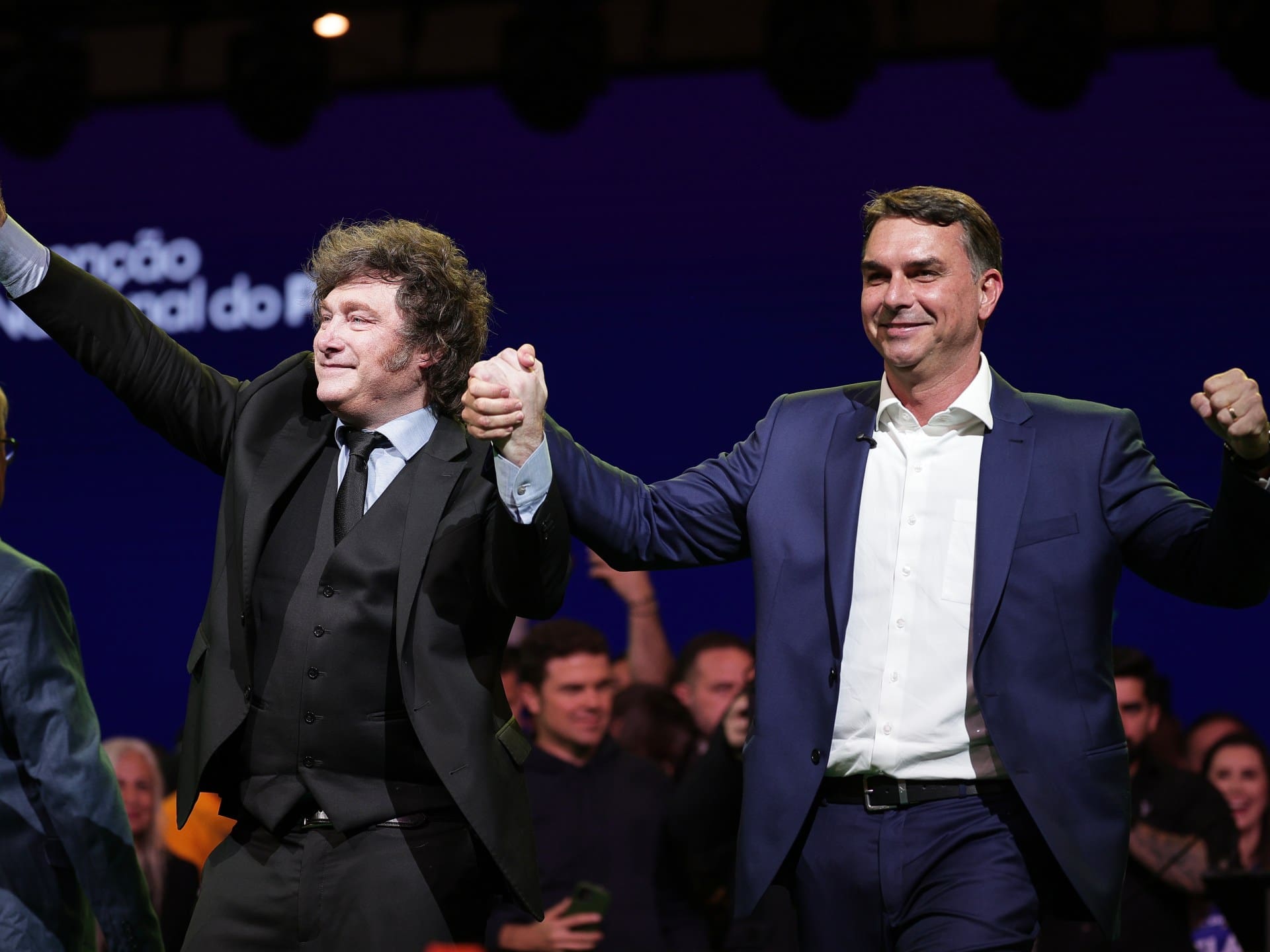 Brazilian Sen. Flavio Bolsonaro, right, and Argentina's President Javier Milei greet supporters during the Liberal Party convention where Bolsonaro was confirmed as the party's presidential candidate, in Sao Paulo, Saturday, July 25, 2026. (AP Photo/Ettore Chiereguini)