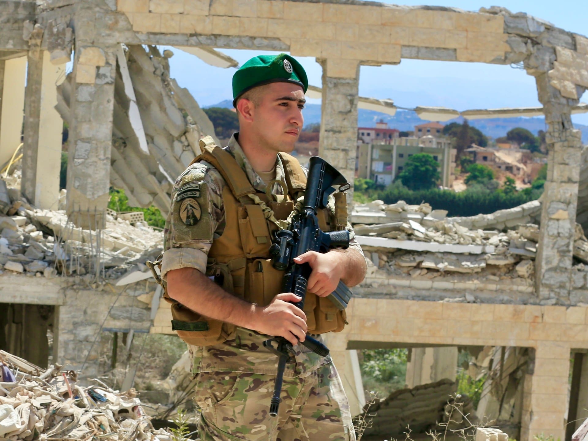 epa13133947 A Lebanese army soldier patrols past a destroyed building in the village of Zawtar al-Gharbiyeh in southern Lebanon, 26 July 2026. Zawtar al-Gharbiya is among the designated pilot zones under the ceasefire agreement between Lebanon and Israel, from which Israeli forces are scheduled to withdraw. EPA/STRINGER