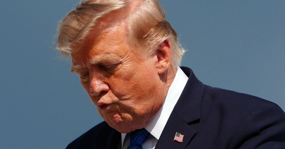 US President Donald Trump gestures while stepping off Air Force One upon arrival at Morristown Municipal Airport in Morristown, New Jersey, on July 31, 2026.
